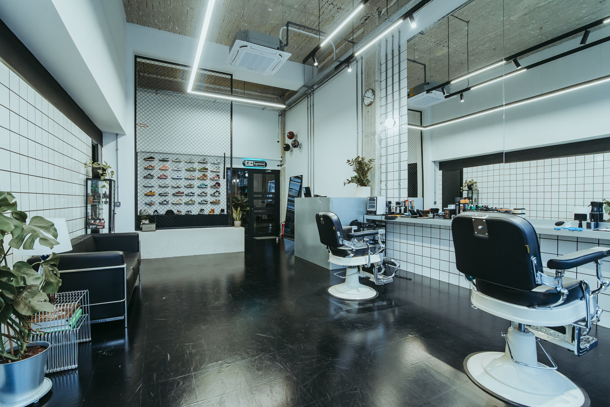 Head2Toe barbershop interior with sneaker wall
